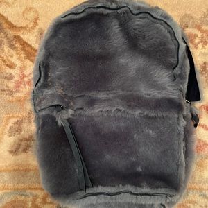 Shearling gray furry knapsack with navy suede accents & interior.